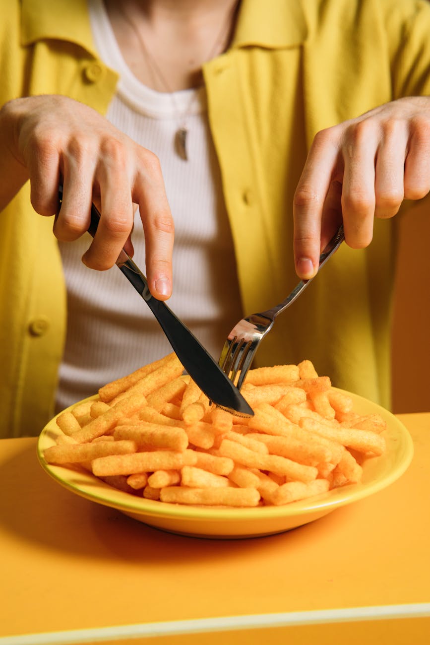 crop photo of a guy eating fries