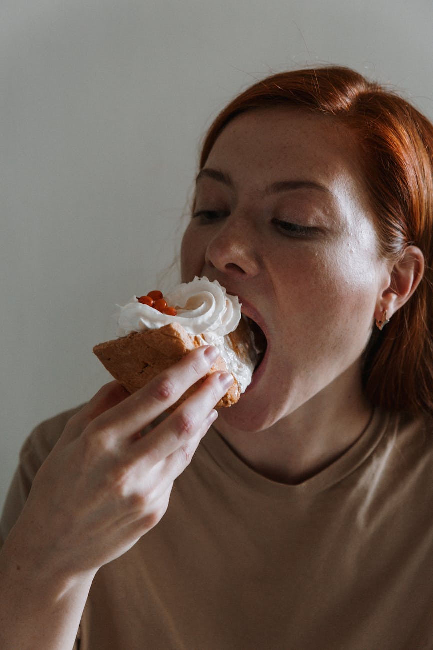 woman eating baked good dessert
